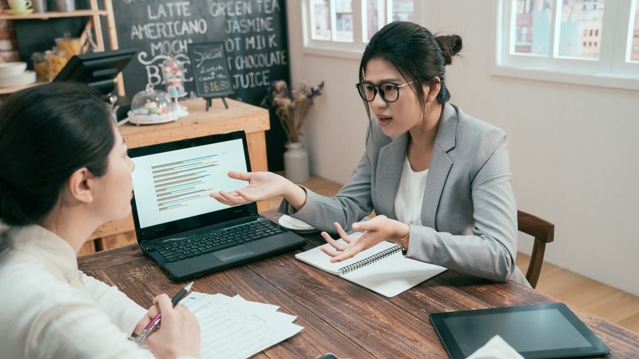 asian office workers arguing